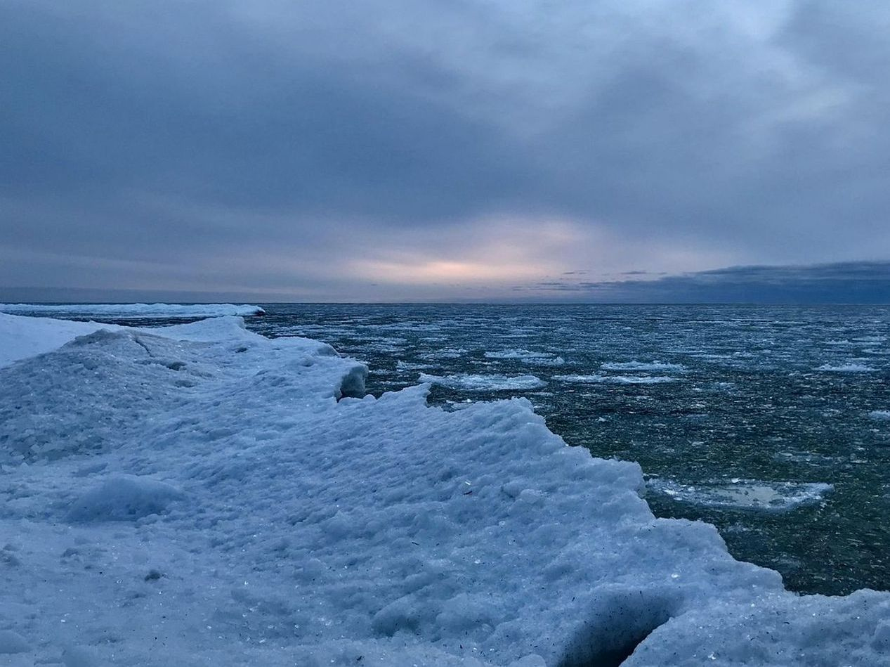 Lago de montaña cubierto de hielo al amanecer
